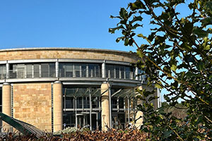 Gateway Building, with holly leaves in the foreground
